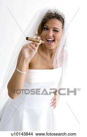 Picture - Bride smoking a cigar. Fotosearch