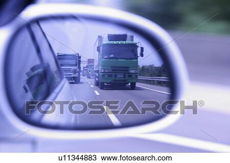 Stock Image - Driving, Streets, Motor vehicle, Outdoors, Vehicle, Driving mirrors. Fotosearch