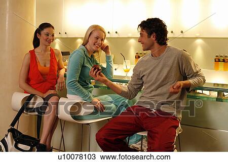 Friends having a refreshment at the bar after a spa treatment View Large Photo Image Stock Image - Friends having a refreshment at the bar after a spa treatment. Fotosearch