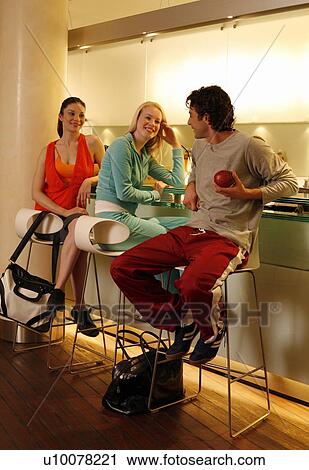 Stock Image - Friends having a refreshment at the bar after a spa treatment. Fotosearch