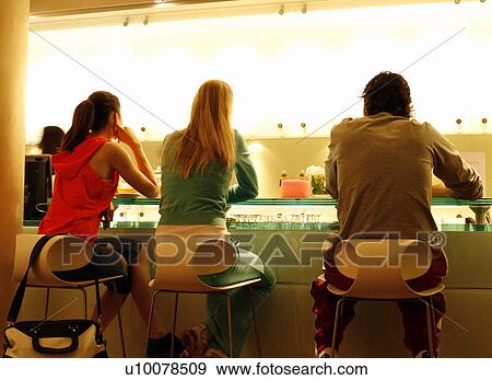Friends having a refreshment at the bar after a spa treatment View Large Photo Image Stock Photo - Friends having a refreshment at the bar after a spa treatment. Fotosearch