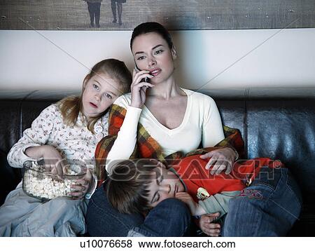 Mother and children watching television View Large Photo Image Stock Photo - Mother and children watching television. Fotosearch