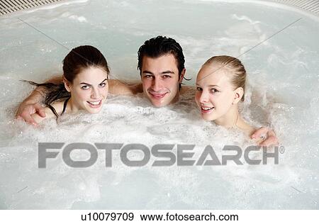 One man with two women in jacuzzi at a spa View Large Photo Image Stock Photo - One man with two women in jacuzzi at a spa. Fotosearch