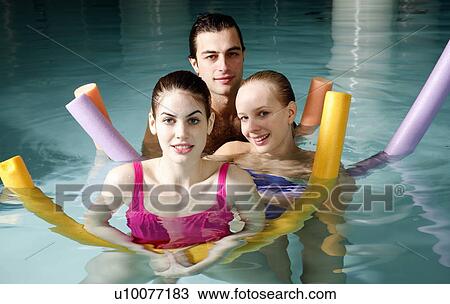 Stock Image - People exercising in a spa pool. Fotosearch