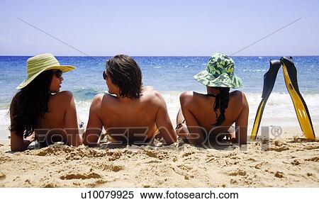 Two women and a man with flippers on the beach View Large Photo Image Stock Photography - Two women and a man with flippers on the beach. Fotosearch