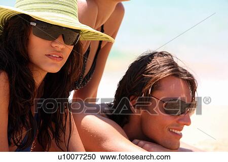 Stock Image - Young couple on the beach. Fotosearch