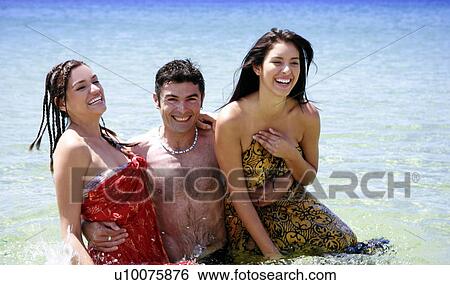 Young people playing around in the water View Large Photo Image Stock Photograph - Young people playing around in the water. Fotosearch