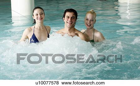 Stock Photo - Young people swimming in spa pool. Fotosearch