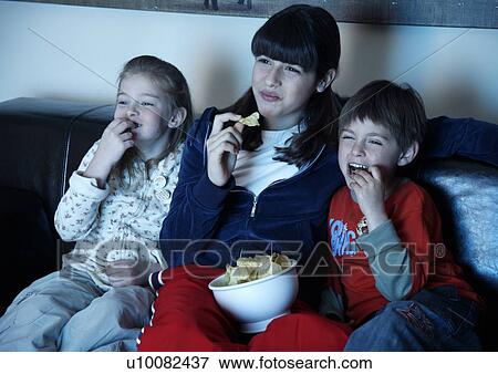 Young people watching television View Large Photo Image Stock Photo - Young people watching television. Fotosearch