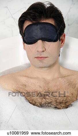 Stock Photo - Man enjoying bubble bath. Fotosearch