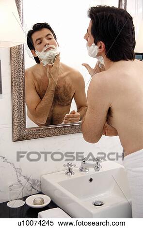 Man shaving in the bathroom mirror View Large Photo Image Stock Photography - Man shaving in the bathroom mirror. Fotosearch