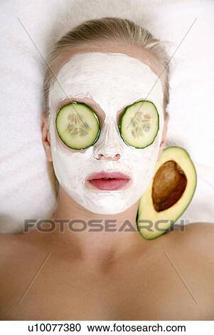 Stock Image - Woman having a facial treatment in a spa. Fotosearch