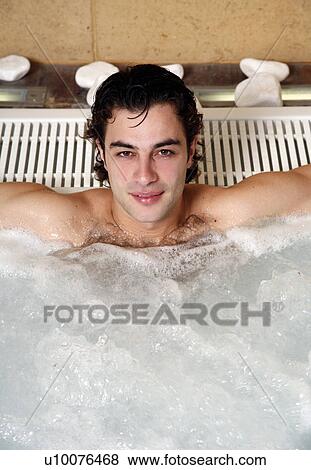 Young man in jacuzzi at a spa View Large Photo Image Stock Photo - Young man in jacuzzi at a spa. Fotosearch