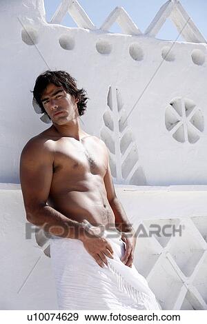 Young man wearing pareo View Large Photo Image Stock Photo - Young man wearing pareo. Fotosearch