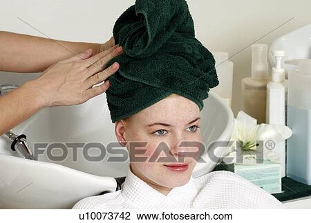 Young woman having her hair washed at a salon View Large Photo Image Stock Image - Young woman having her hair washed at a salon. Fotosearch