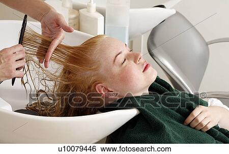 Young woman having her hair washed at a salon View Large Photo Image Stock Photograph - Young woman having her hair washed at a salon. Fotosearch
