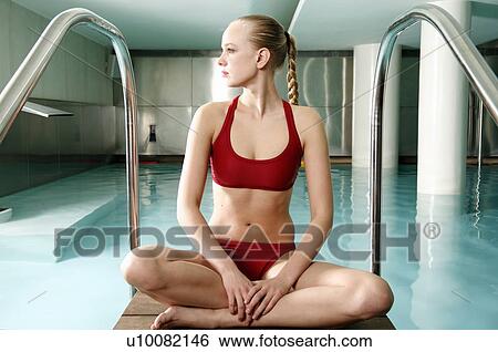 Stock Photograph - Young woman in a swimming pool at a spa. Fotosearch