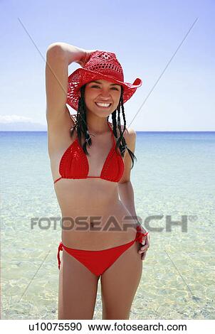 Young woman in bikini and hat on the beach View Large Photo Image Stock Image - Young woman in bikini and hat on the beach. Fotosearch