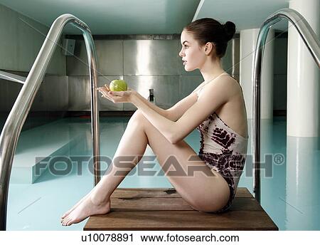 Young woman sitting next to spa pool View Large Photo Image Stock Image - Young woman sitting next to spa pool. Fotosearch