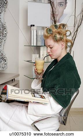 Young woman sitting under hairdryer View Large Photo Image Stock Image - Young woman sitting under hairdryer. Fotosearch
