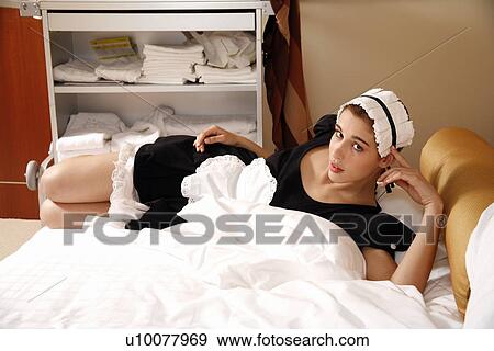 Stock Photo - Hotel maid taking a break. Fotosearch