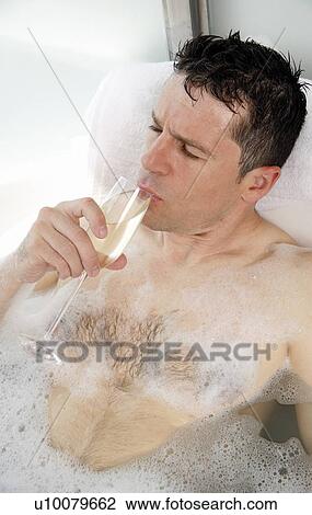 Man relaxing in bathtub with bubbles View Large Photo Image Stock Image - Man relaxing in bathtub with bubbles. Fotosearch