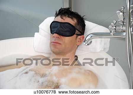 Man relaxing in bathtub with bubbles View Large Photo Image Stock Photo - Man relaxing in bathtub with bubbles. Fotosearch