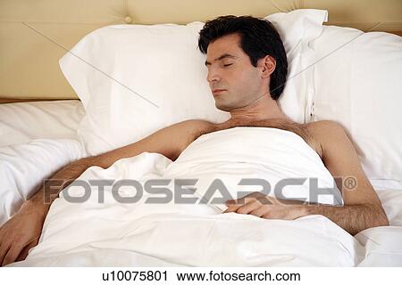 Man sleeping in bed View Large Photo Image Stock Image - Man sleeping in bed. Fotosearch