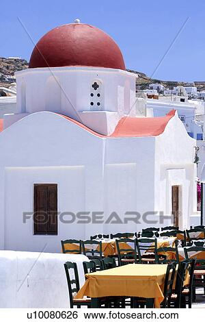 Stock Photograph - Restaurant tables in front of church. Fotosearch