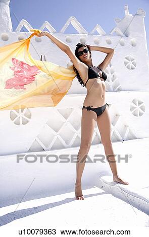 Woman in bikini holding pareo View Large Photo Image Stock Image - Woman in bikini holding pareo. Fotosearch