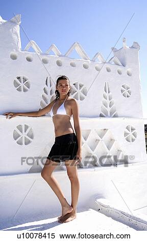 Stock Photography - Woman in skirt and bikini top. Fotosearch