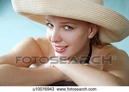 Stock Image - Young woman in a swimming pool at a spa. Fotosearch