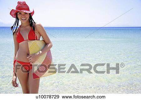 Young woman with bikini, hat, and beach bag View Large Photo Image Stock Photo - Young woman with bikini, hat, and beach bag. Fotosearch