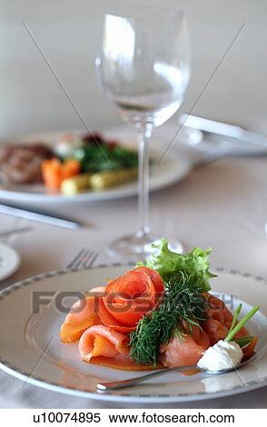 Stock Photography - Smoked salmon dish on dinner table. Fotosearch