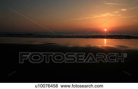 Stock Photo - View of sunset over water. Fotosearch
