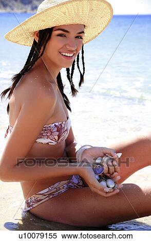 Young woman in bikini and hat on beach View Large Photo Image Stock Photography - Young woman in bikini and hat on beach. Fotosearch