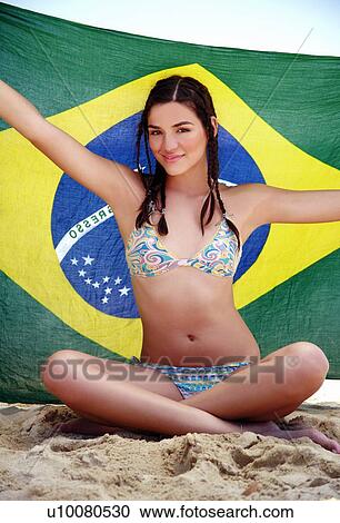 Young woman in bikini holding up a scarf View Large Photo Image Stock Image - Young woman in bikini holding up a scarf. Fotosearch