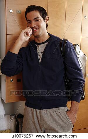 Man in locker room after work out talking on cell phone View Large Photo Image Stock Photo - Man in locker room after work out talking on cell phone. Fotosearch