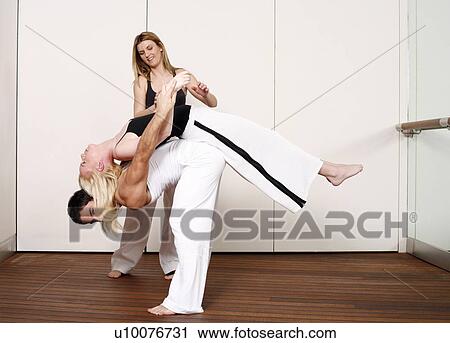 Partners practicing flexibility in yoga and Capoeira programs View Large Photo Image Stock Image - Partners practicing flexibility in yoga and Capoeira programs. Fotosearch