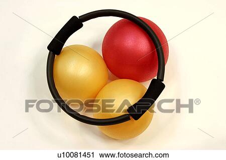 Stock Image - Pilates ring with exercise balls. Fotosearch