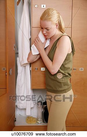 Woman in locker room after work out View Large Photo Image Stock Photo - Woman in locker room after work out. Fotosearch