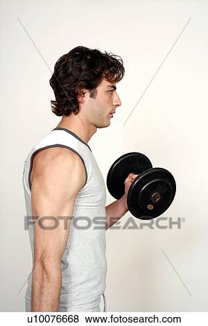 Young man lifting weights View Large Photo Image Stock Photo - Young man lifting weights. Fotosearch
