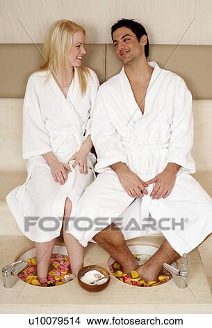A young couple enjoying a foot bath with rose petals View Large Photo Image Picture - A young couple enjoying a foot bath with rose petals. Fotosearch