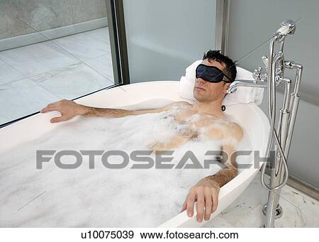 Man relaxing in bathtub with bubbles View Large Photo Image Stock Photo - Man relaxing in bathtub with bubbles. Fotosearch