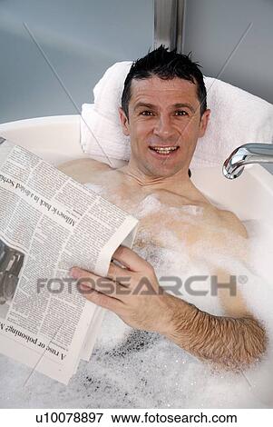 Man relaxing in bathtub with bubbles View Large Photo Image Stock Photo - Man relaxing in bathtub with bubbles. Fotosearch