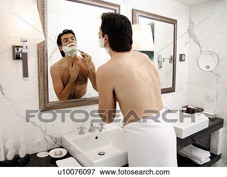 Man shaving in the bathroom mirror View Large Photo Image Stock Photo - Man shaving in the bathroom mirror. Fotosearch