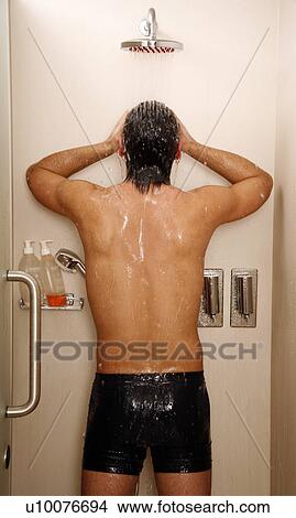 Picture - Man taking a shower at the gym. Fotosearch