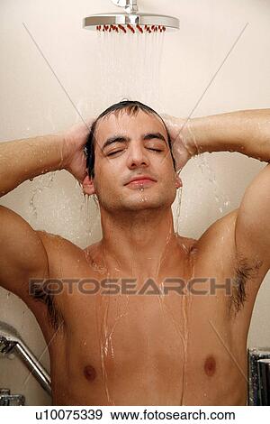 Stock Photo - Man taking a shower at the gym. Fotosearch