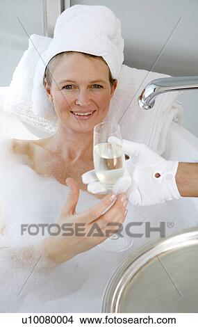 Mature woman enjoying bubble bath Picture | u10080004 | Fotosearch