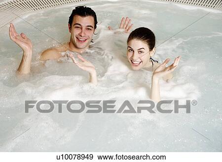 Stock Photo - One man with one woman in jacuzzi at a spa. Fotosearch